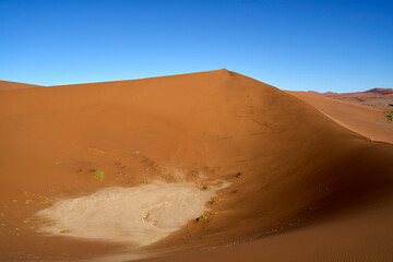 The trail up to Big Daddy with view of an enclosed saltpan with a ridge on all sides. Sossusvlei, Namibia.