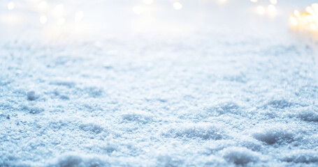 Obraz premium Winter snow background with snowdrifts, with lights on the blue sky in the evening, banner format, copy space. Snowy weather