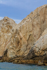 A rocky cliff with a blue sky in the background