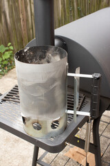 Charcoal starter sitting on a smoker Barbeque