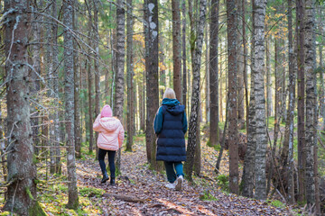 Capturing the love between a mother and daughter on an autumn day in the woods.