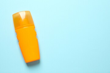 Top view of SPF skin care bottle on colored background