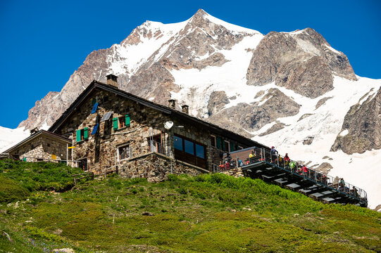 Aosta Valley, Italy The Elisabetta Hut refuge and restaurant terrace, on the background of the Mont Blanc mountain
