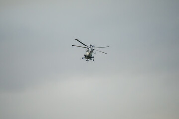 helicopter flying fast and low over open countryside