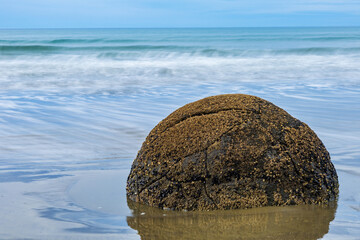 Long exposure shot of Moeraki Boulders in New Zealand. Famous landmark large spherical stones on Koekohe Beach near Moeraki on New Zealand's Otago coast. A popular tourist attraction