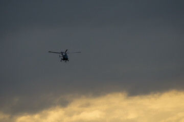helicopter flying fast and low over open countryside