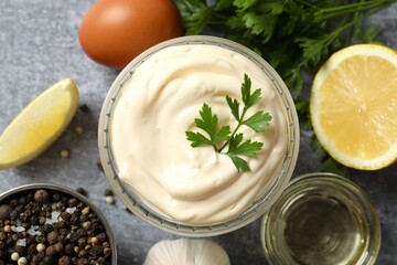Bowl with mayonnaise and ingredients for cooking on the table