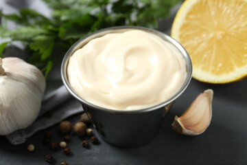 Bowl with mayonnaise and ingredients for cooking on the table