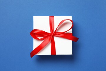 Beautiful gift box on color background