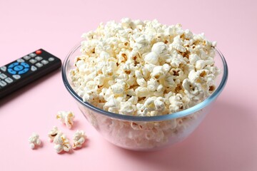 Delicious popcorn in a bowl on a colored background