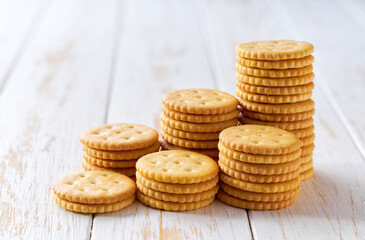 Small pile of round crackers a light kitchen table, selective focus.