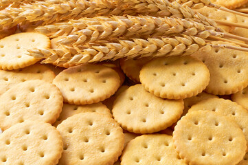 Tasty round crackers on a white table, close up.