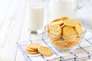 Low-calories round crackers and a jug of fresh milk on a light kitchen table, healthy breakfast.