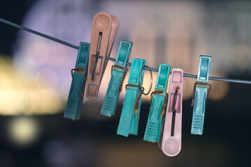 Colorful clothespins hanging on a drying line, selective focus