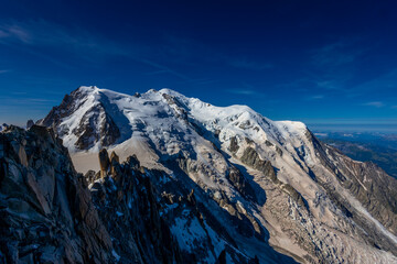 Obraz premium Mont Blanc, Monte Bianco mountain summit in the Alps. The highest mountain in Europe. Snow and glacier covered high altitude snow mountain in the Alps. The top of Montblanc Chamonix valley landscape