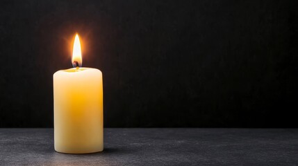Single Burning Candle on Dark Background - Peace, remembrance, hope, serenity, light. A single candle flame illuminates the darkness.