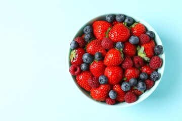 Different fresh ripe berries as a background, top view