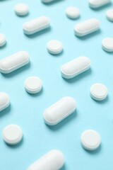 White pills on a color background