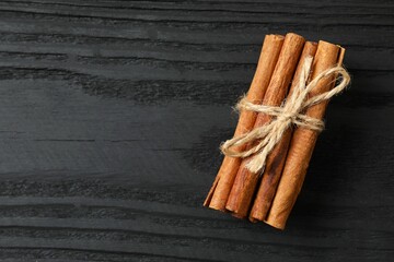 Cinnamon sticks on a wooden background