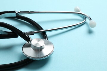 Stethoscope on color background