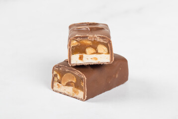 Vegan bar. Nougat, caramel with peanuts, in chocolate. Close-up