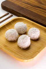 Japanese dessert mochi with red bean filling and coconut flakes. chopsticks.  food concept.