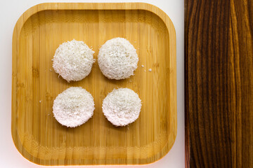Japanese dessert mochi with red bean filling and coconut flakes. chopsticks.  food concept.