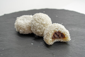 Japanese dessert mochi with red bean filling and coconut flakes. chopsticks.  food concept.