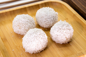 Japanese dessert mochi with red bean filling and coconut flakes. chopsticks.  food concept.