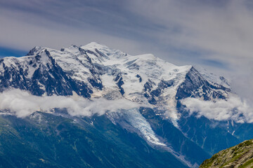 Fototapeta premium Mont Blanc, Monte Bianco mountain summit in the Alps. The highest mountain in Europe. Snow and glacier covered high altitude snow mountain in the Alps. The top of Montblanc Chamonix valley landscape