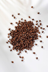 Fresh coffee beans in a mug and background.