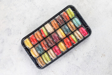 Colorful french dessert macarons with fresh fruits and nuts.