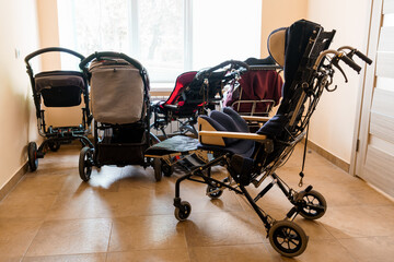 A Variety of Strollers and Prams Arranged Neatly in a Room