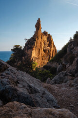 a landscape of a stone cliff in the warm sunset