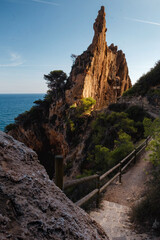 a landscape of a stone cliff in the warm sunset