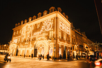 Fototapeta premium Illuminated Luxury Storefront in a Festive City Street at Night
