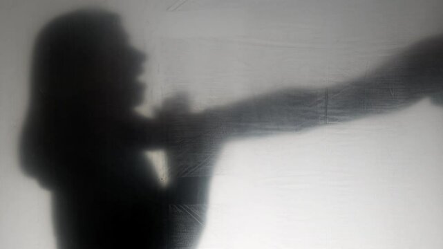 A hand reaches out to strangle a woman. Concept of violence and horror.