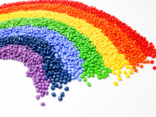 Various colors of masterbatch granules arranged like a rainbow, polymer carrier of color pigments...