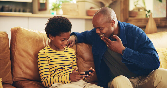Bonding, dad and child with smartphone, gaming and man with gesture for boy, playing and fun for score. House, father and gamer with mobile app in lounge, African and sign language for deaf kid - Powered by Adobe