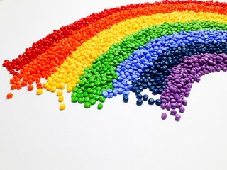 Various colors of masterbatch granules arranged like a rainbow, polymer carrier of color pigments in the plastic industry. Suitable for plastic company catalog design