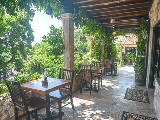 Fototapeta premium Cozy outdoor dining area surrounded by lush greenery and vibrant plants.