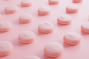 Obraz premium Pink macaroons on a pink background. A delicate French dessert. 