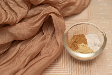 Christmas homemade baking, spices for gingerbread in glass bowl, brown cloth