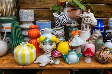 Ceramic vases designed as women’s heads, animals, and piggy banks shaped like frogs and mushrooms.