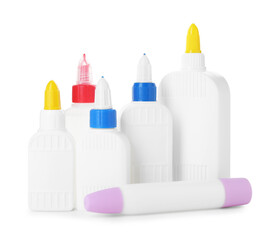 Bottles and sticks of glue on white background
