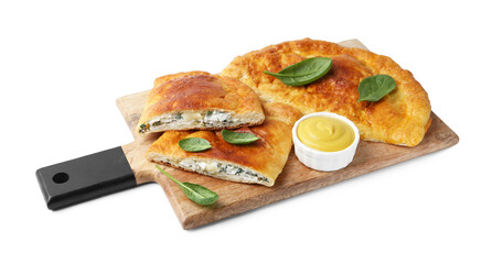 Tasty calzones with basil, cheese and sauce isolated on white