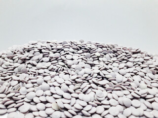 Recycled plastic pellets with white background, ready for re-production into plastic products.