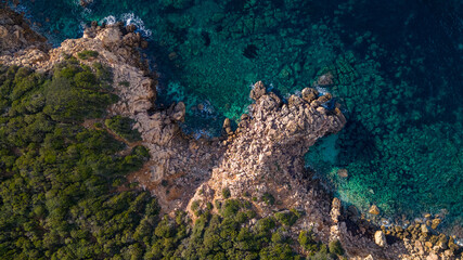 Italian beach in Sardinia, crystal clear sea and green vegetation