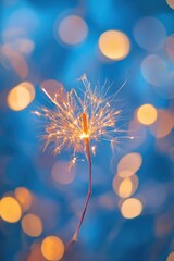 Obraz premium Glowing sparkler against a bokeh background.