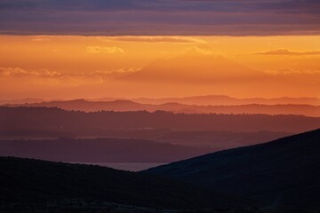 Obraz premium Sunset Hilly Landscape, volcano in the distant background